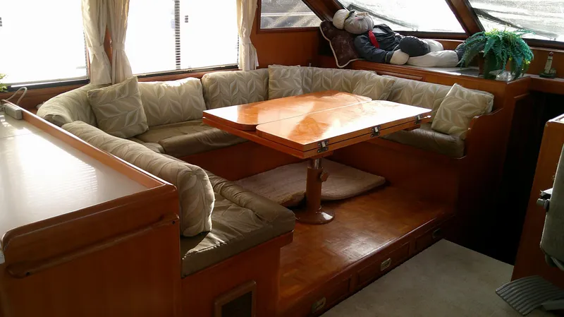 Slide: The Image of Interior of 1996 Ocean Alexander 546 Yachtfisher with cozy seating and wooden table. - 40