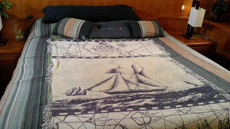 Slide: The Image of Cozy bed with nautical-themed blanket in 1996 Ocean Alexander 546 Yachtfisher cabin. - 42