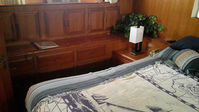 Slide: The Image of Bedroom interior of 1996 Ocean Alexander 546 Yachtfisher with wooden cabinetry and decorative lamp. - 43