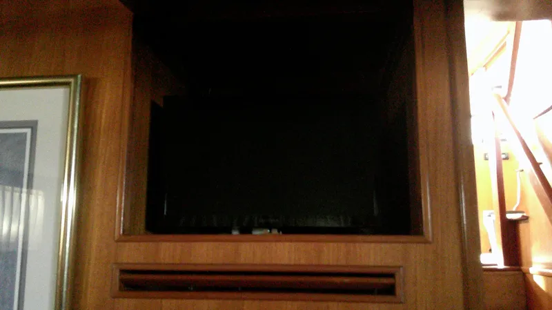 Slide: The Image of Interior of 1996 Ocean Alexander 546 Yachtfisher with wooden paneling and framed artwork. - 45