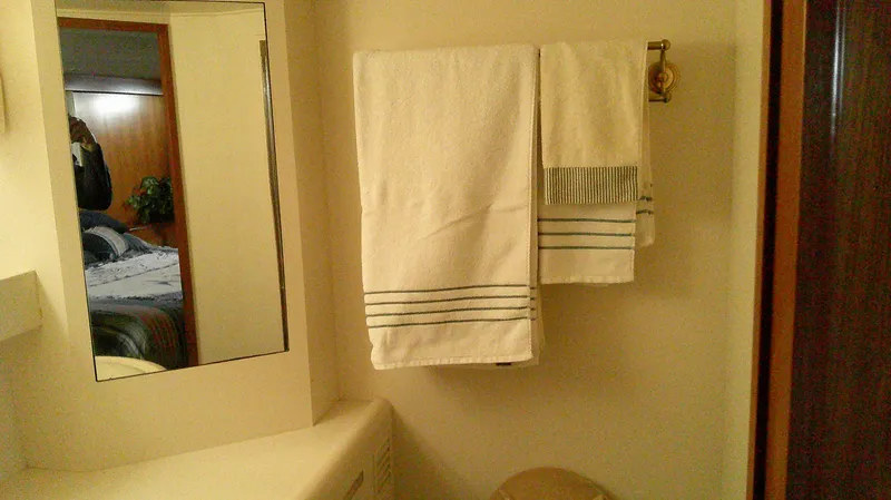 Slide: The Image of Bathroom interior of 1996 Ocean Alexander 546 Yachtfisher with towels and mirror. - 49