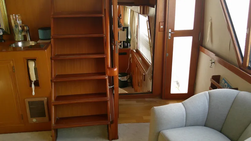 Slide: The Image of Interior of 1996 Ocean Alexander 546 Yachtfisher with wooden stairs and cozy seating. - 5