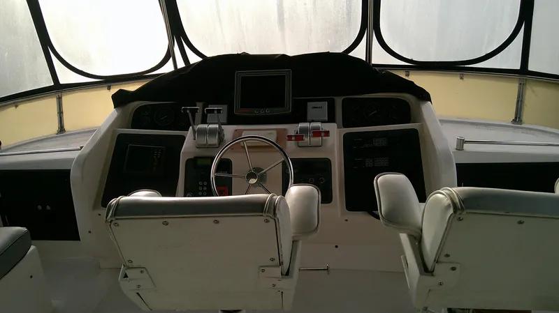 Slide: The Image of 1996 Ocean Alexander 546 Yachtfisher helm with dual seats and navigational controls. - 9