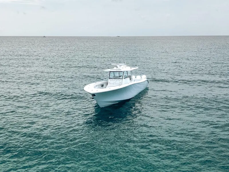 Slide: The Image of 2019 Yellowfin 42 boat on open sea, calm waters, overcast sky. - 14