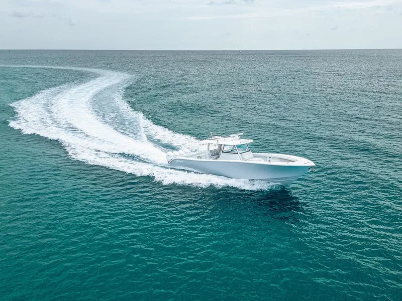 Slide: The Image of 2019 Yellowfin 42 boat cruising on open ocean, leaving a wake trail. - 17