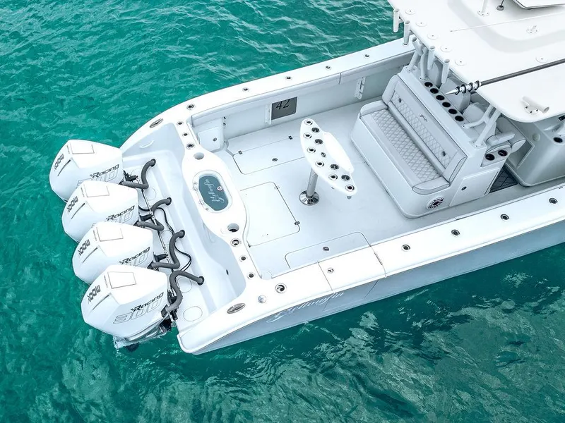 Slide: The Image of 2019 Yellowfin 42 boat with triple outboard engines on turquoise water. - 20