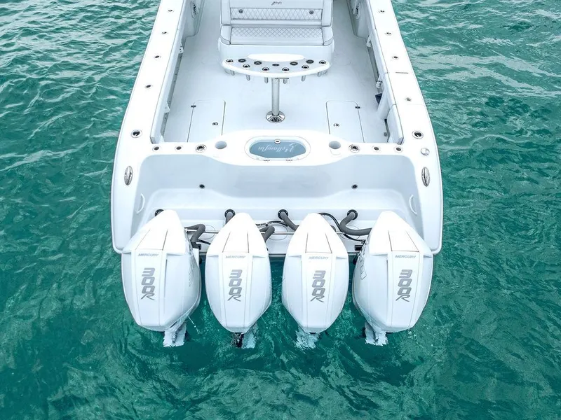 Slide: The Image of 2019 Yellowfin 42 boat with four powerful outboard engines on turquoise water. - 22