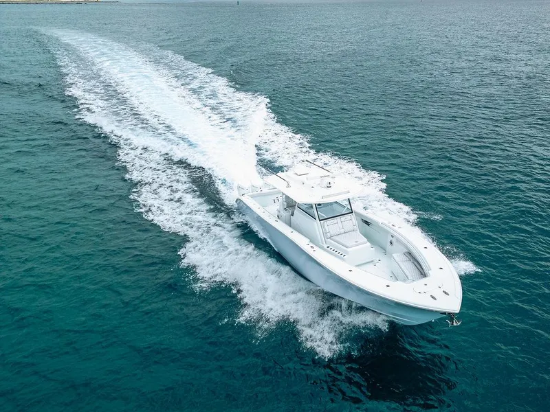 Slide: The Image of 2019 Yellowfin 42 boat cruising on open water, leaving a trail of white wake. - 23