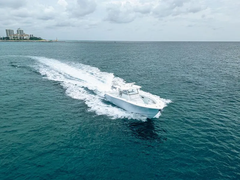 Slide: The Image of 2019 Yellowfin 42 boat cruising on open ocean under cloudy sky. - 24