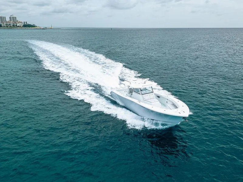 Slide: The Image of 2019 Yellowfin 42 boat cruising on open ocean under cloudy sky. - 26