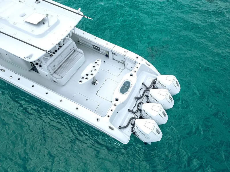 Slide: The Image of 2019 Yellowfin 42 boat with triple outboard engines on clear turquoise water. - 28