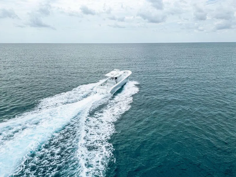 Slide: The Image of 2019 Yellowfin 42 boat cruising on open ocean under cloudy sky. - 3