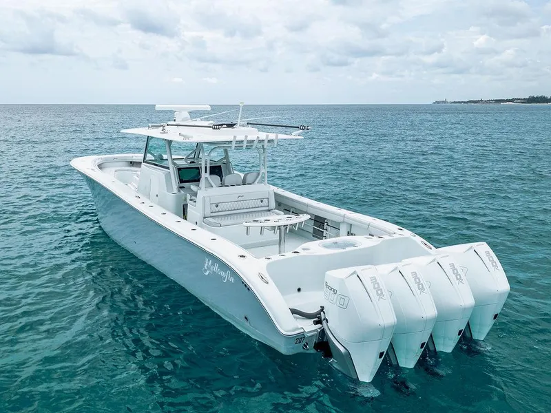 Slide: The Image of 2019 Yellowfin 42 boat with triple outboard engines on clear blue water. - 31