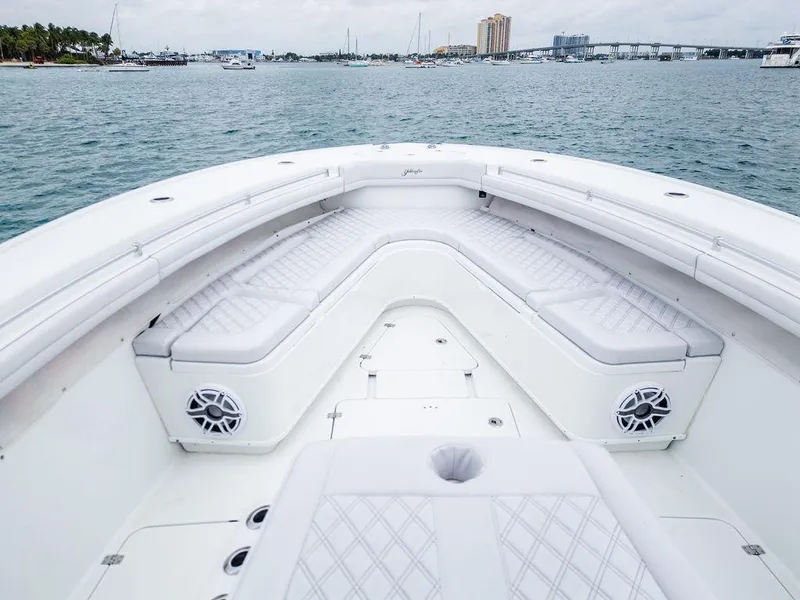Slide: The Image of 2019 Yellowfin 42 boat with spacious seating, on calm waters, near a city skyline. - 33