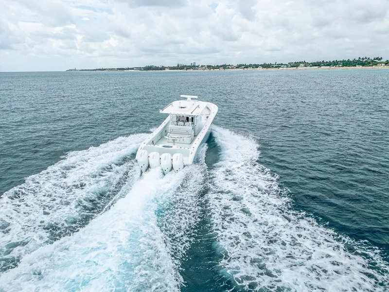 Slide: The Image of 2019 Yellowfin 42 boat cruising on open ocean with wake trails. - 34