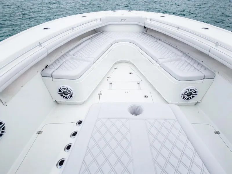 Slide: The Image of 2019 Yellowfin 42 boat interior with white cushioned seating and ocean backdrop. - 35