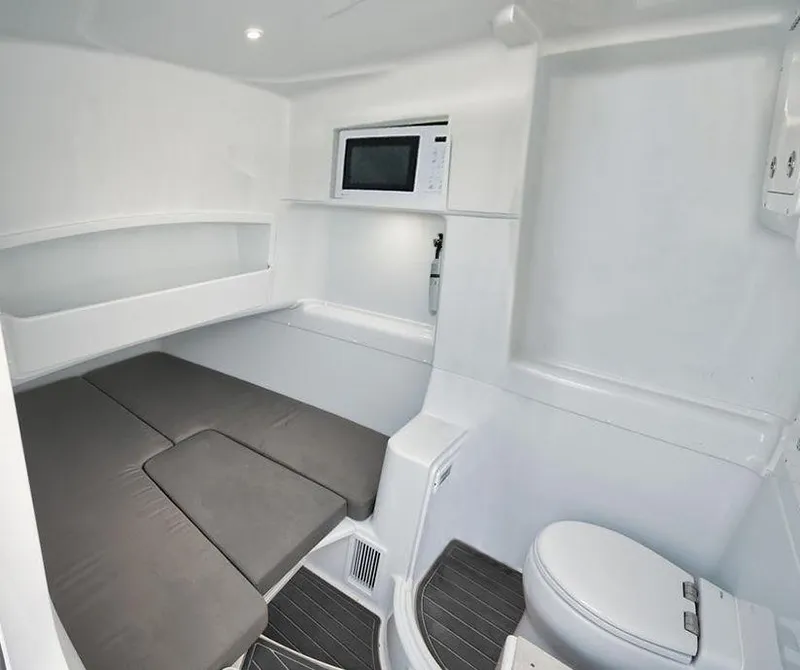 Slide: The Image of 2019 Yellowfin 42 interior cabin with bed, microwave, and toilet. - 37