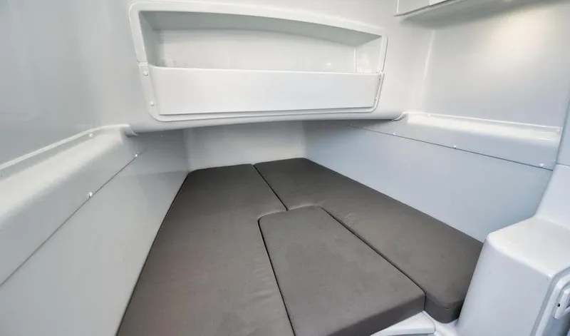Slide: The Image of 2019 Yellowfin 42 interior cabin with gray cushions and white walls. - 40