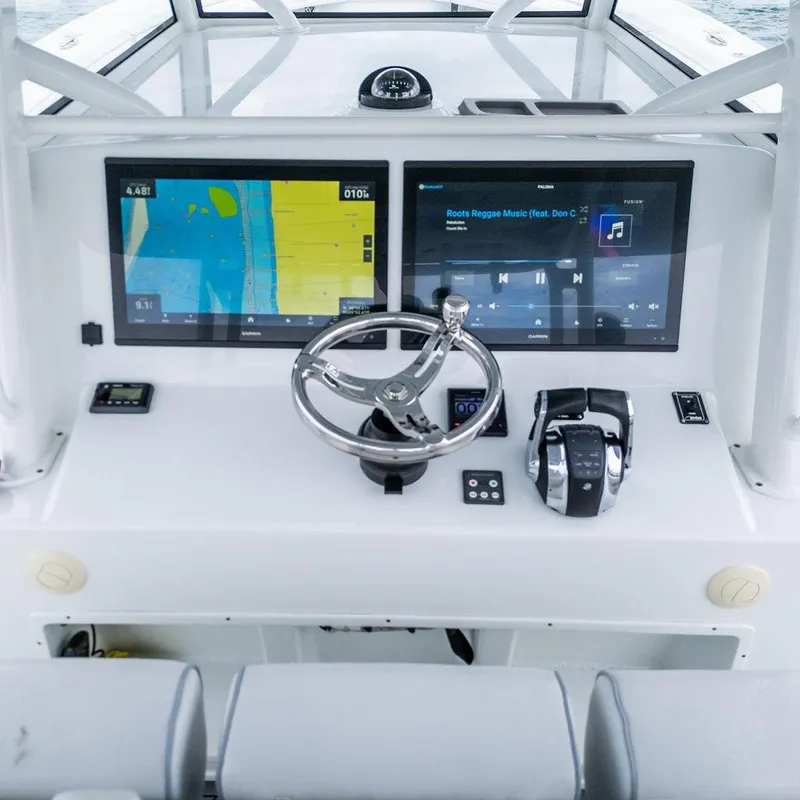 Slide: The Image of 2019 Yellowfin 42 boat dashboard with dual screens and steering wheel. - 42