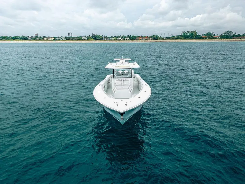Slide: The Image of 2019 Yellowfin 42 boat on calm ocean near coastline under cloudy sky. - 7