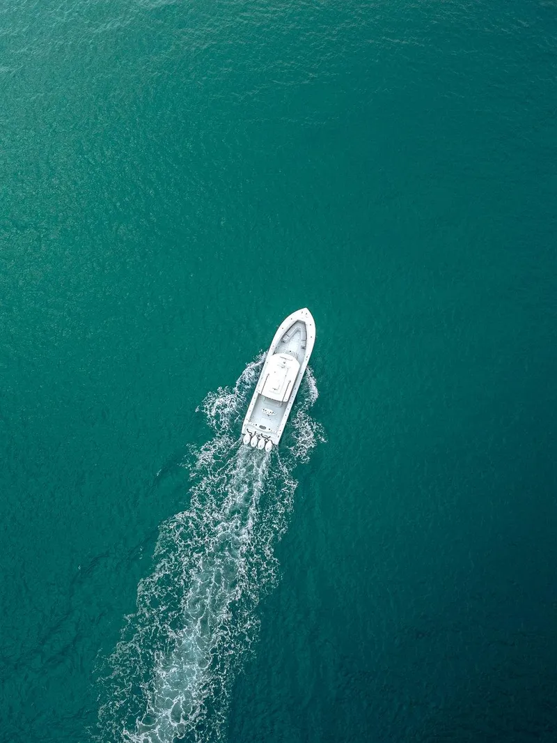 Slide: The Image of Aerial view of 2019 Yellowfin 42 boat cruising on turquoise water. - 9