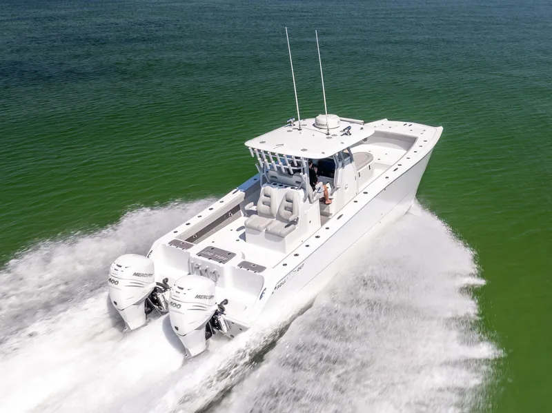 Slide: The Image of 2022 Freeman 34VH boat cruising on open water, featuring dual Mercury engines. - 10