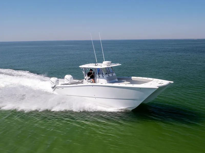 Slide: The Image of 2022 Freeman 34VH boat cruising on open water, showcasing sleek design and performance. - 11