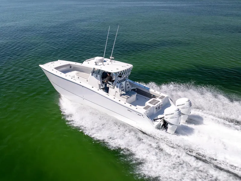 Slide: The Image of Freeman 34VH 2022 boat cruising on clear green water, showcasing powerful twin engines. - 13