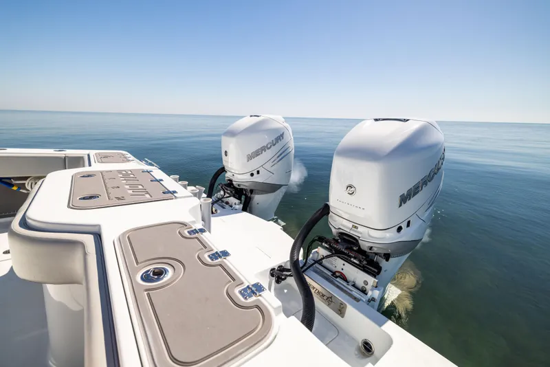 Slide: The Image of 2022 Freeman 34VH boat with dual Mercury outboard engines on calm sea. - 16