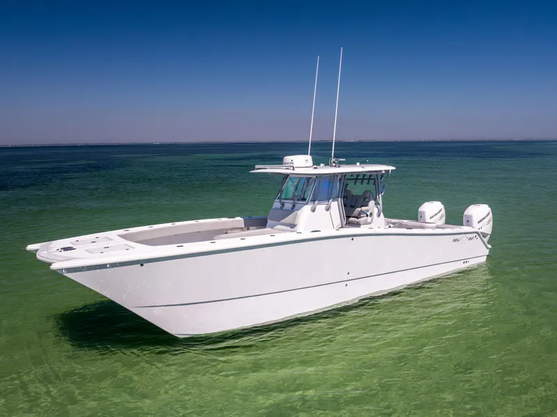 Slide: The Image of 2022 Freeman 34VH boat on clear green water under blue sky. - 2