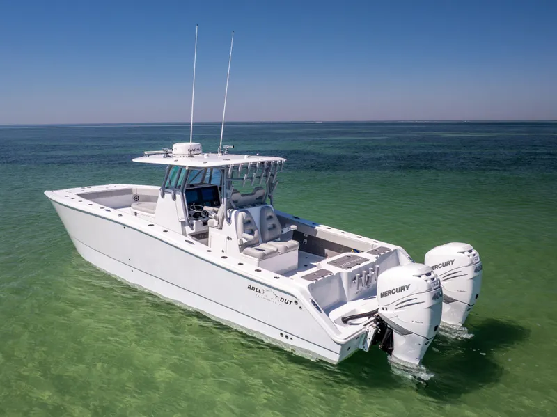 Slide: The Image of 2022 Freeman 34VH boat with twin Mercury engines on clear green water. - 3