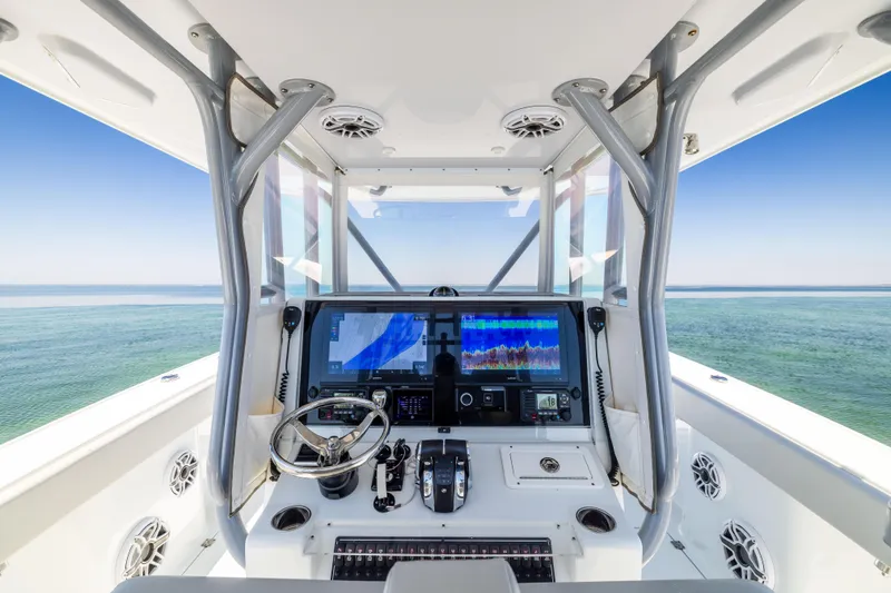 Slide: The Image of 2022 Freeman 34VH boat cockpit with advanced navigation system on open water. - 33