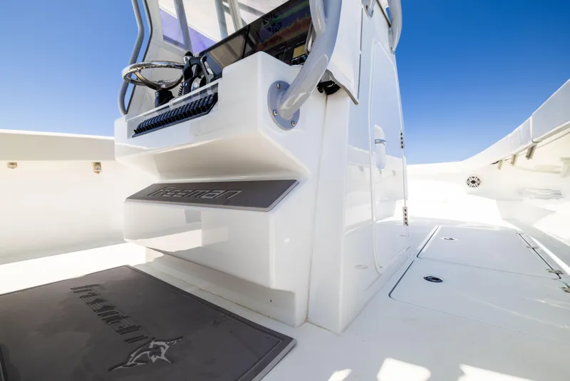 Slide: The Image of Freeman 34VH 2022 boat interior with steering console and clean white deck. - 36