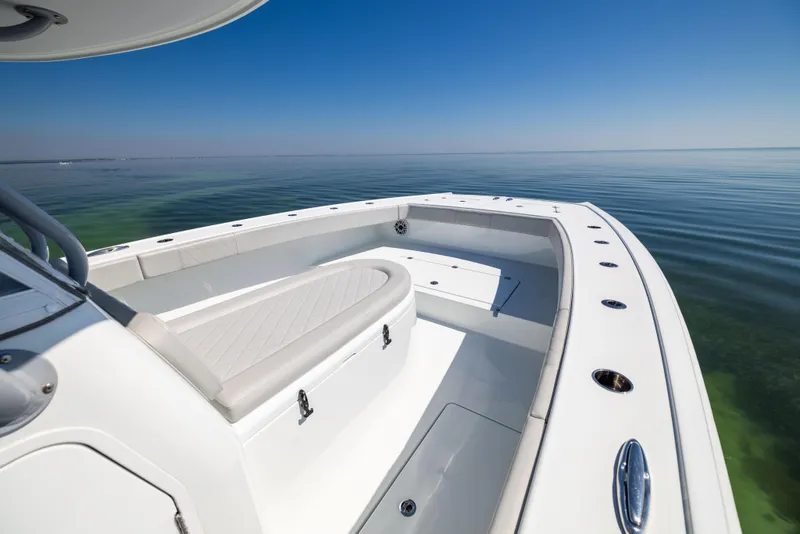 Slide: The Image of 2022 Freeman 34VH boat on calm water, showcasing sleek design and spacious deck. - 40