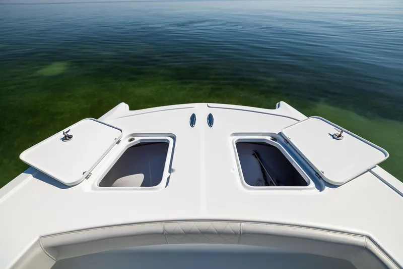 Slide: The Image of Freeman 34VH 2022 boat deck with open storage compartments on calm water. - 42