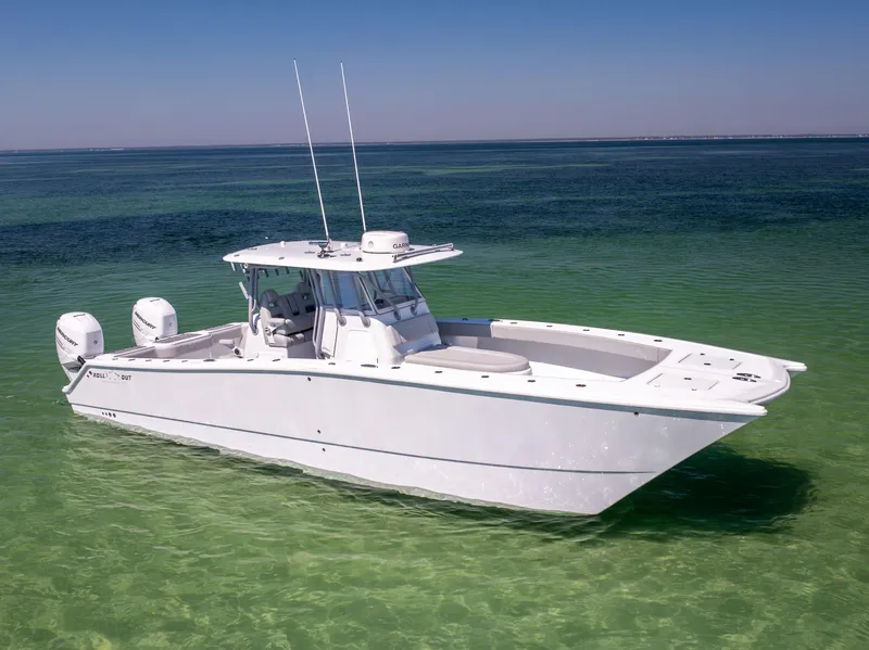 Slide: The Image of Freeman 34VH 2022 boat on clear turquoise water, featuring twin engines and sleek design. - 5