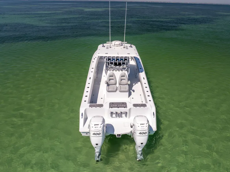 Slide: The Image of 2022 Freeman 34VH boat on clear green water, rear view with twin engines. - 7