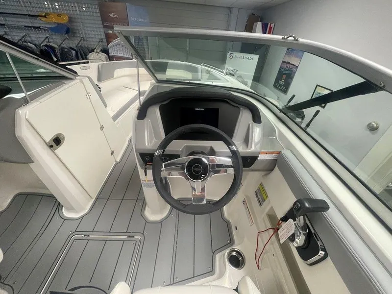 Slide: The Image of 2025 Chaparral 23 SSi boat cockpit with steering wheel and modern dashboard. - 10