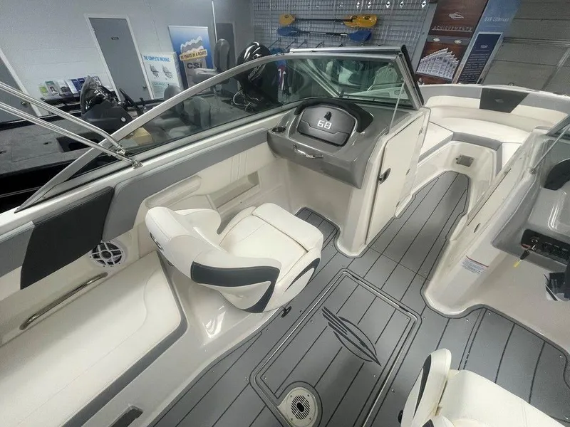 Slide: The Image of 2025 Chaparral 23 SSi boat interior with modern dashboard and seating. - 11