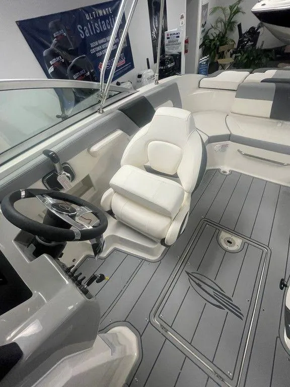 Slide: The Image of 2025 Chaparral 23 SSi boat interior with sleek seating and modern steering console. - 12