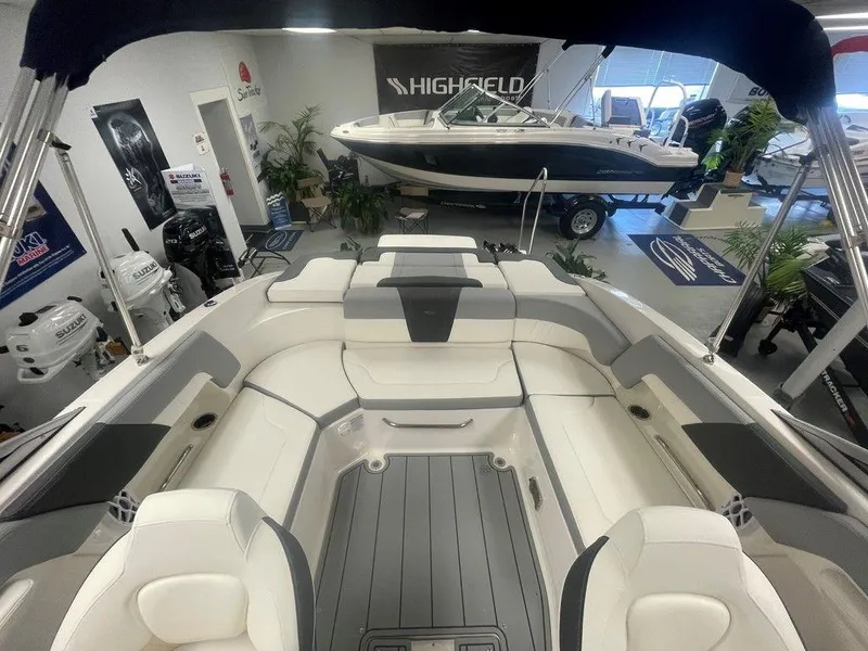 Slide: The Image of 2025 Chaparral 23 SSi boat interior with seating, displayed in showroom. - 15