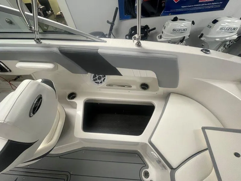 Slide: The Image of Interior view of 2025 Chaparral 23 SSi boat, featuring seating and storage compartments. - 17