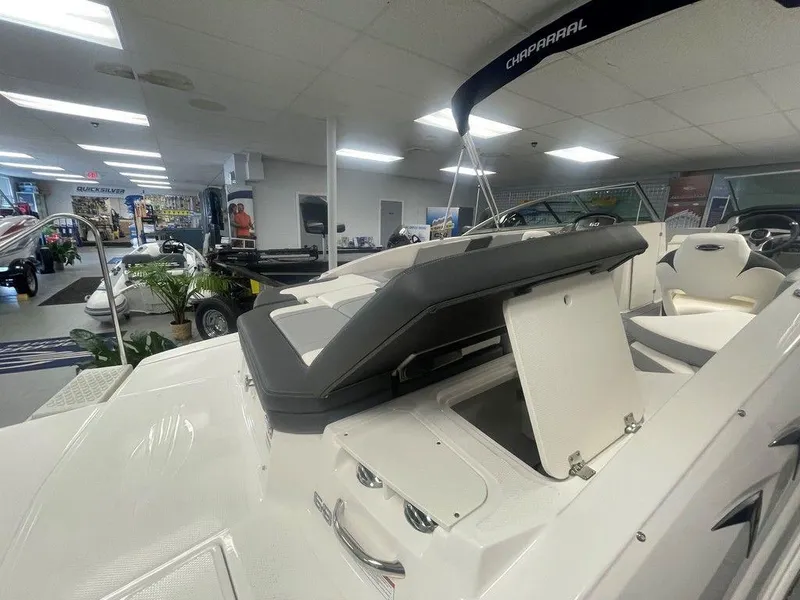 Slide: The Image of 2025 Chaparral 23 SSi boat interior with seating and storage in showroom. - 20