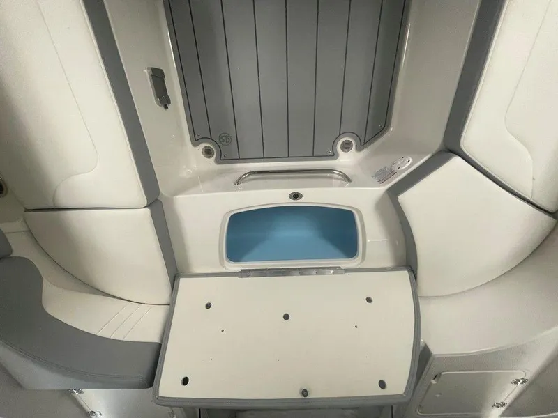 Slide: The Image of 2025 Chaparral 23 SSi boat interior with storage and seating area. - 25