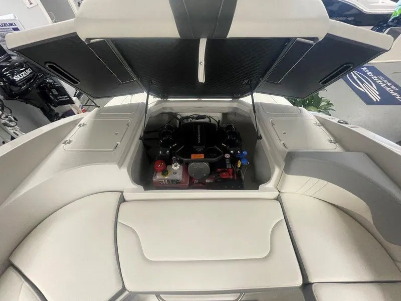 Slide: The Image of 2025 Chaparral 23 SSi boat engine compartment with open hatch, showcasing modern design. - 27