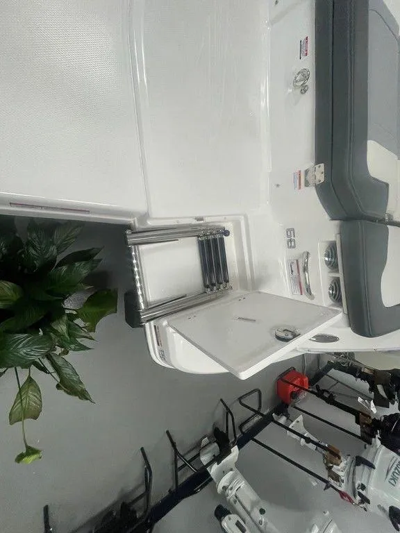 Slide: The Image of 2025 Chaparral 23 SSi boat interior with seating and ladder, showcasing modern design. - 28