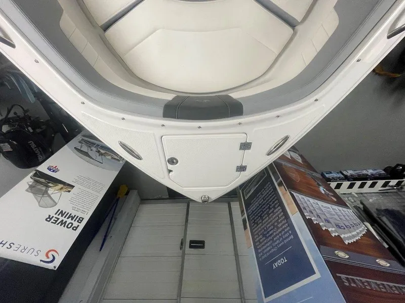 Slide: The Image of 2025 Chaparral 23 SSi boat bow with storage hatch, surrounded by promotional materials. - 29