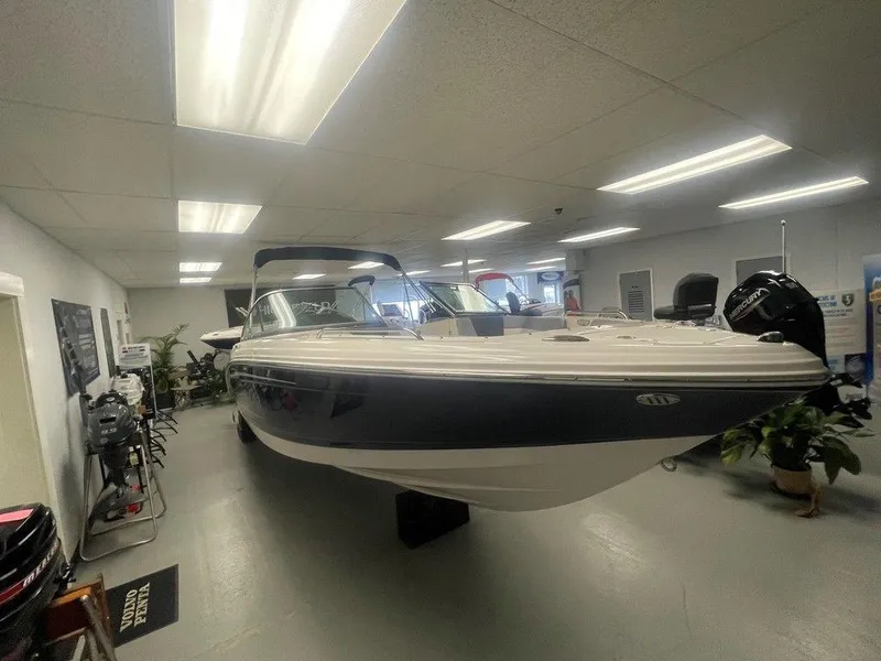 Slide: The Image of 2025 Chaparral 23 SSi boat displayed in a showroom with bright lighting. - 4