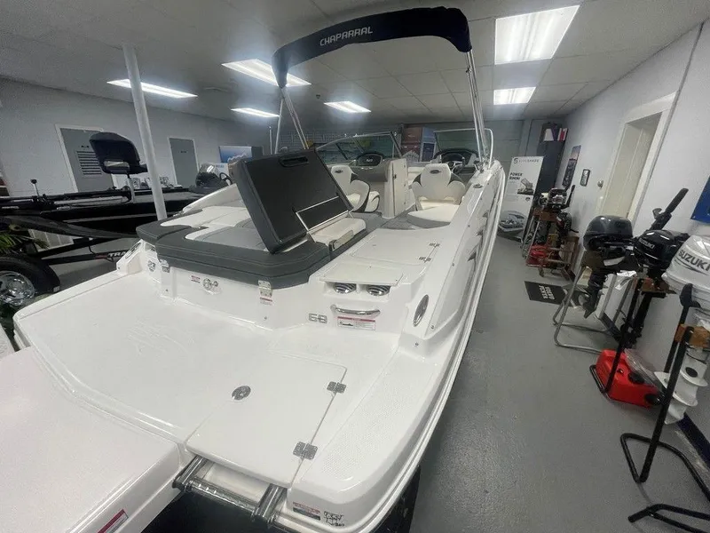 Slide: The Image of 2025 Chaparral 23 SSi boat in showroom, featuring sleek design and spacious deck. - 5