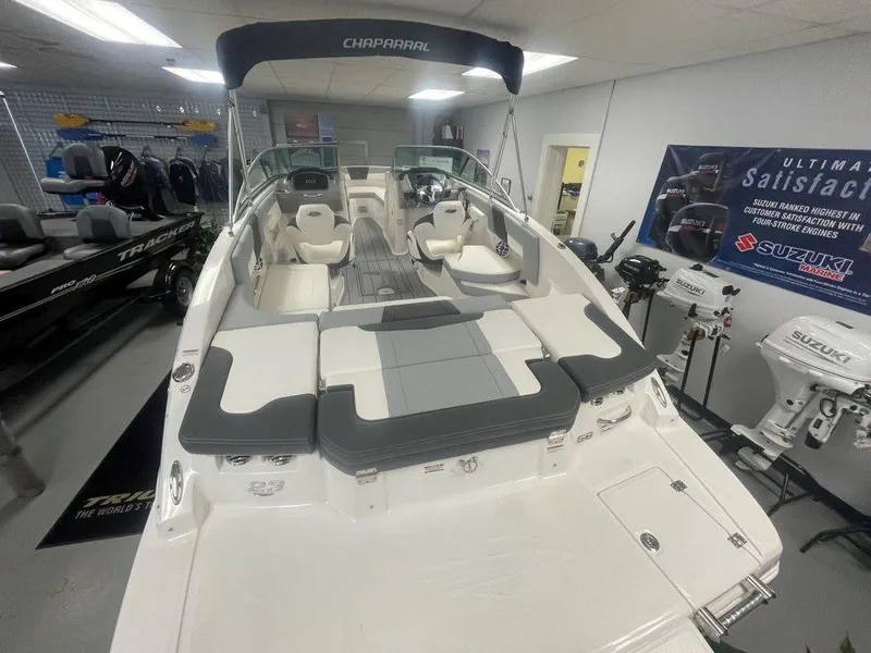 Slide: The Image of 2025 Chaparral 23 SSi boat interior, showroom display with seating and controls. - 7